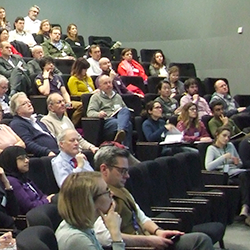 Members of the audience in a lecture theatre at the Early Cancer Institute Annual Symposium